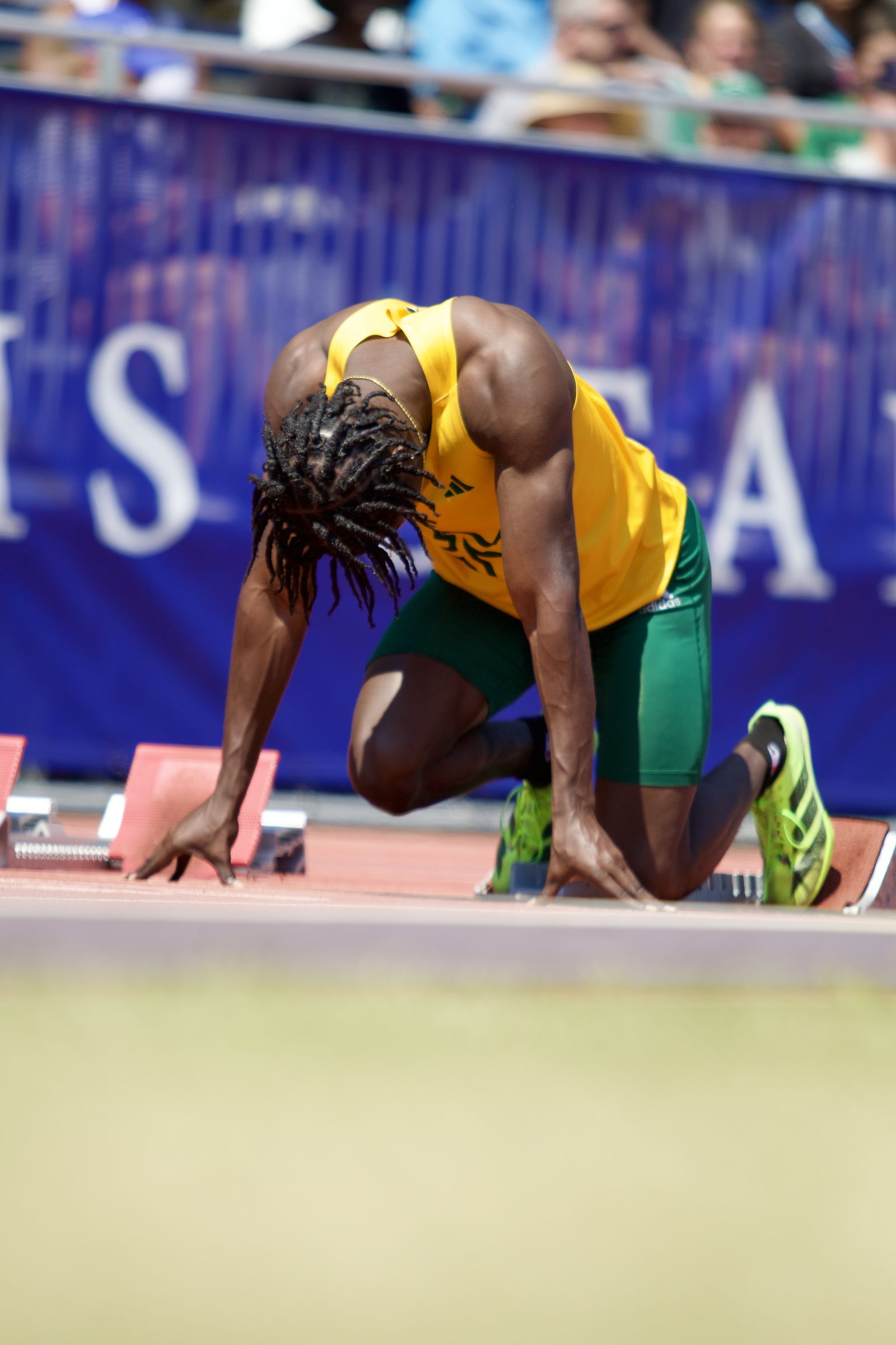 Sprinter in the starting blocks, head down before the gun.