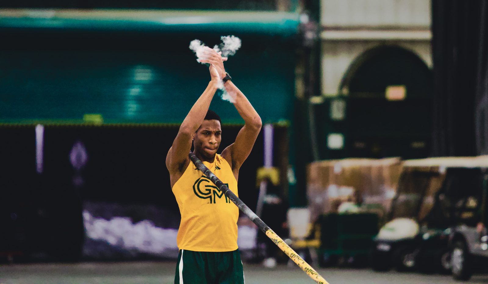 George Mason pole vaulter starting a clap before his attempt at a record height. 